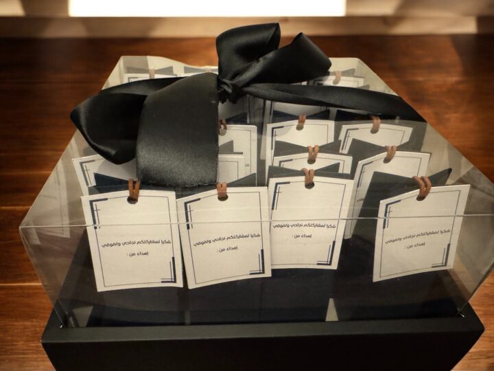 Bulk preparation in a clear gift box with black ribbon for graduation perfume favors in Kuwait