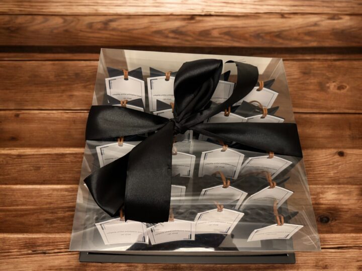 Clear gift box with black ribbon containing graduation & excellence perfume box favors in Kuwait