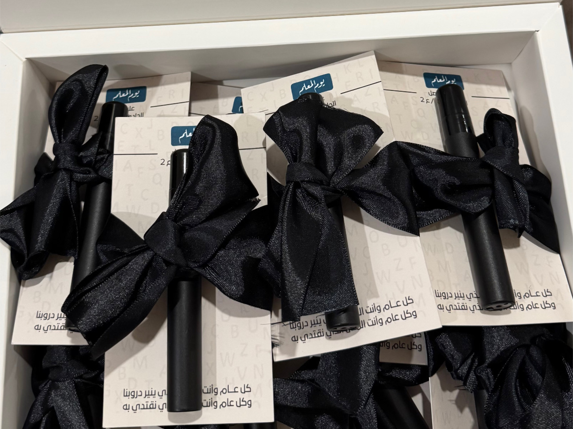 Mini Perfume Spray Favor (Card + Black Ribbon) 1 Bulk box of mini perfume favors (black cases) with black ribbon in Kuwait